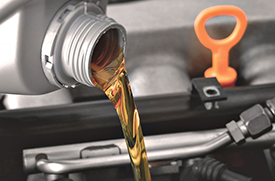 Oil Change Service Image for Doral Acura in Miami, FL - oil being poured into car engine